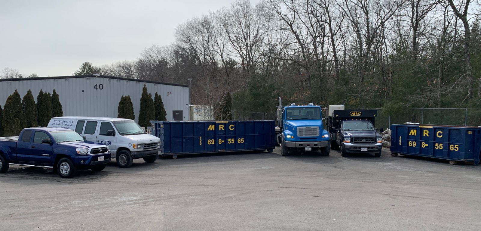 The MRC fleet of navy trucks and roll-off dumpsters at the Bellingham yard